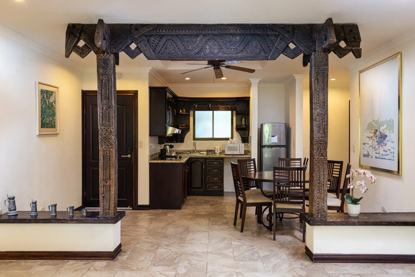 Casita open-plan kitchen and dining room behind carved wood columns