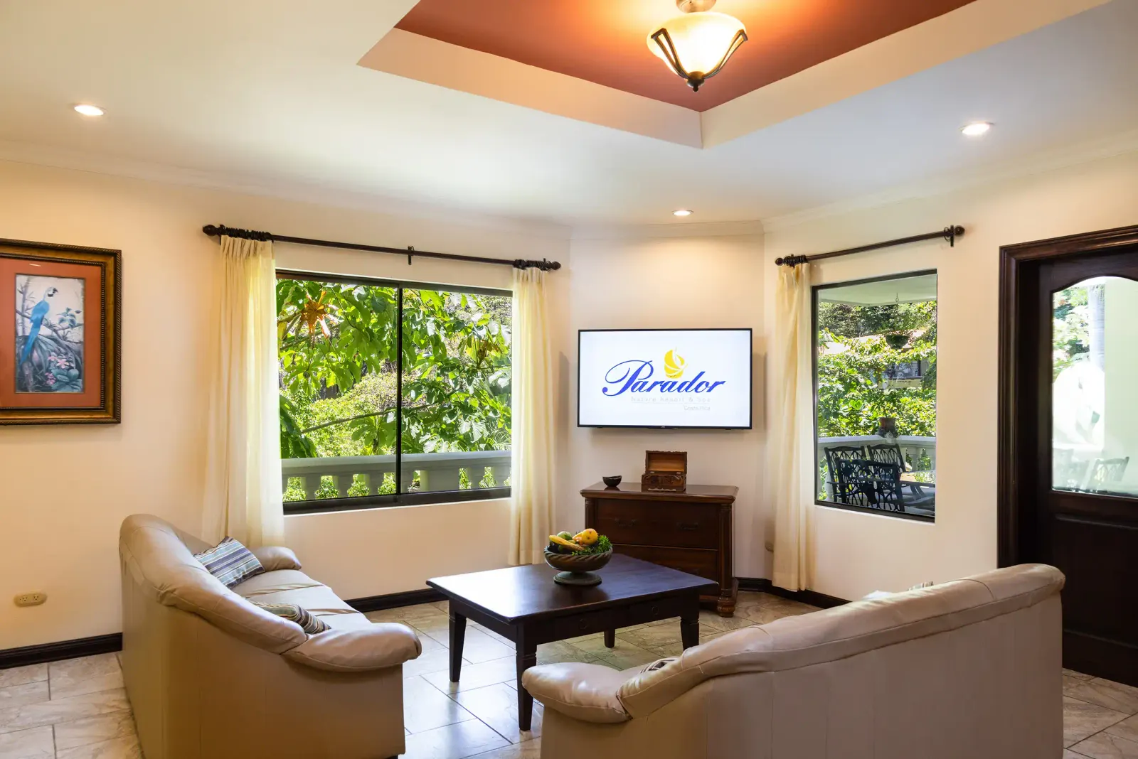 Casita living room with leather sofas and windows onto the garden