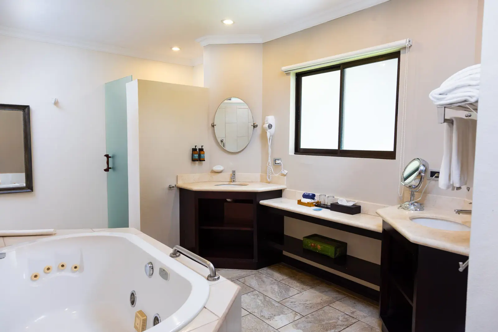 Casita bathroom with a jacuzzi tub, a double vanity and a walk-in shower