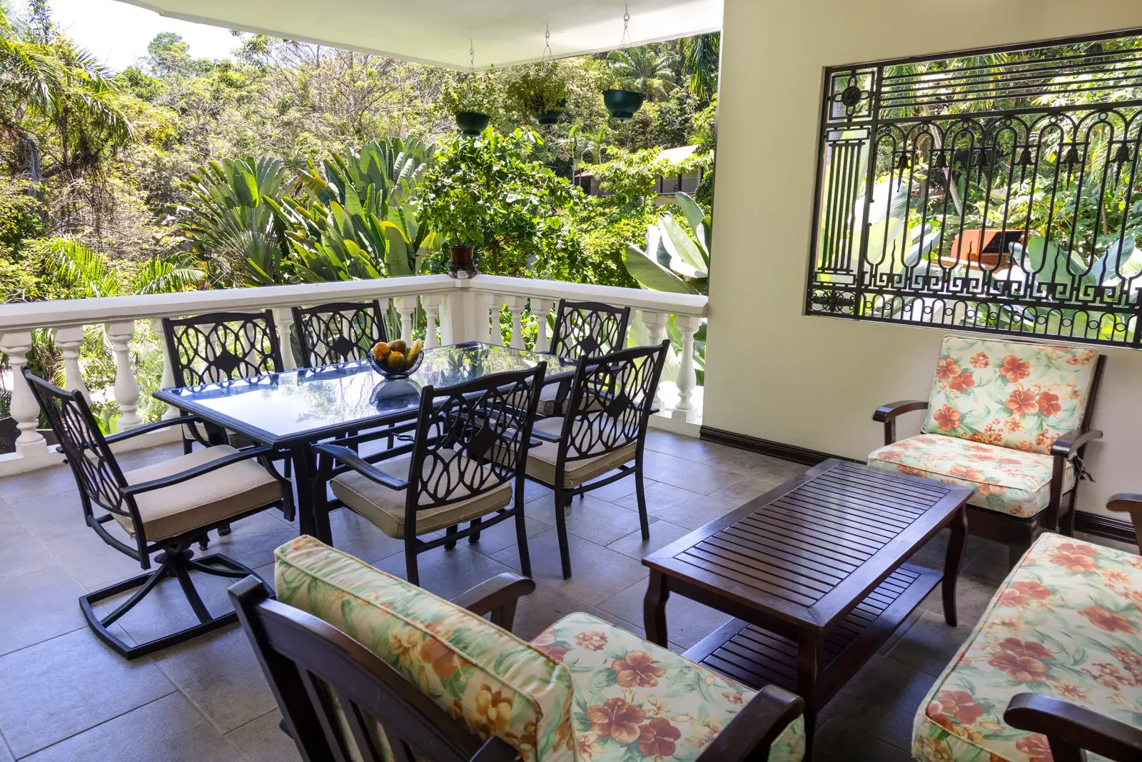 Casita terrace with a dining table and cushioned chairs among the trees