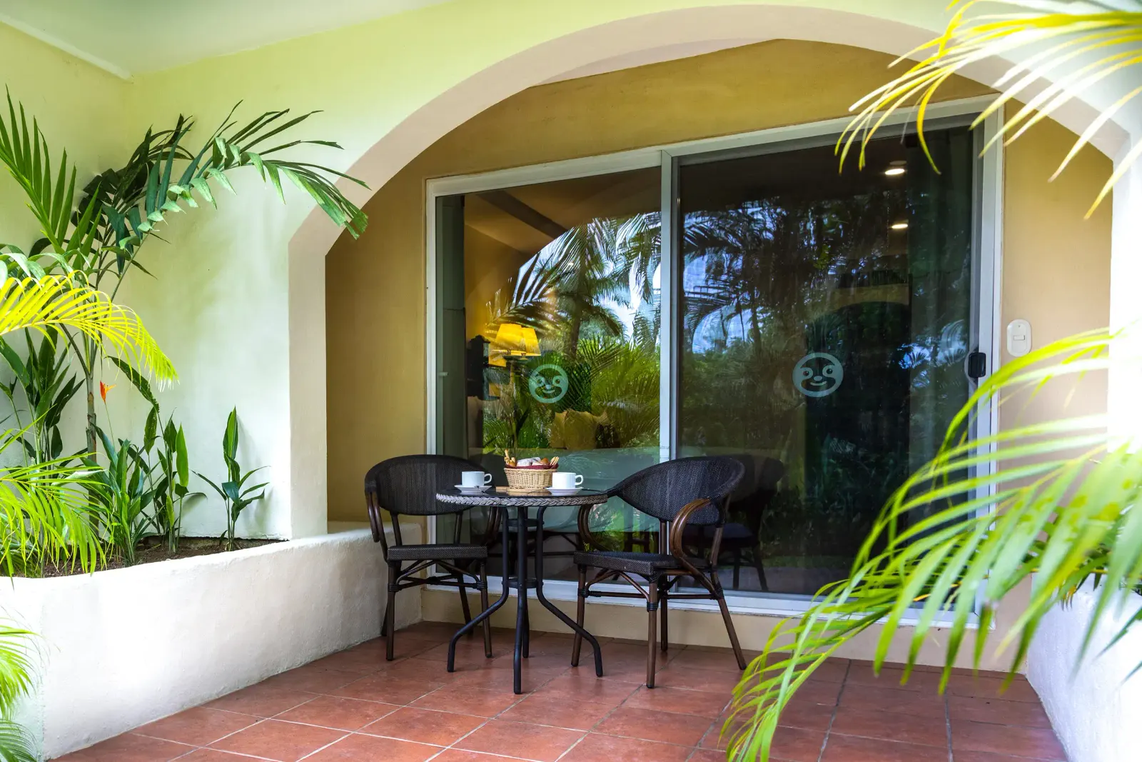 Garden Room patio with a bistro table and chairs among palms