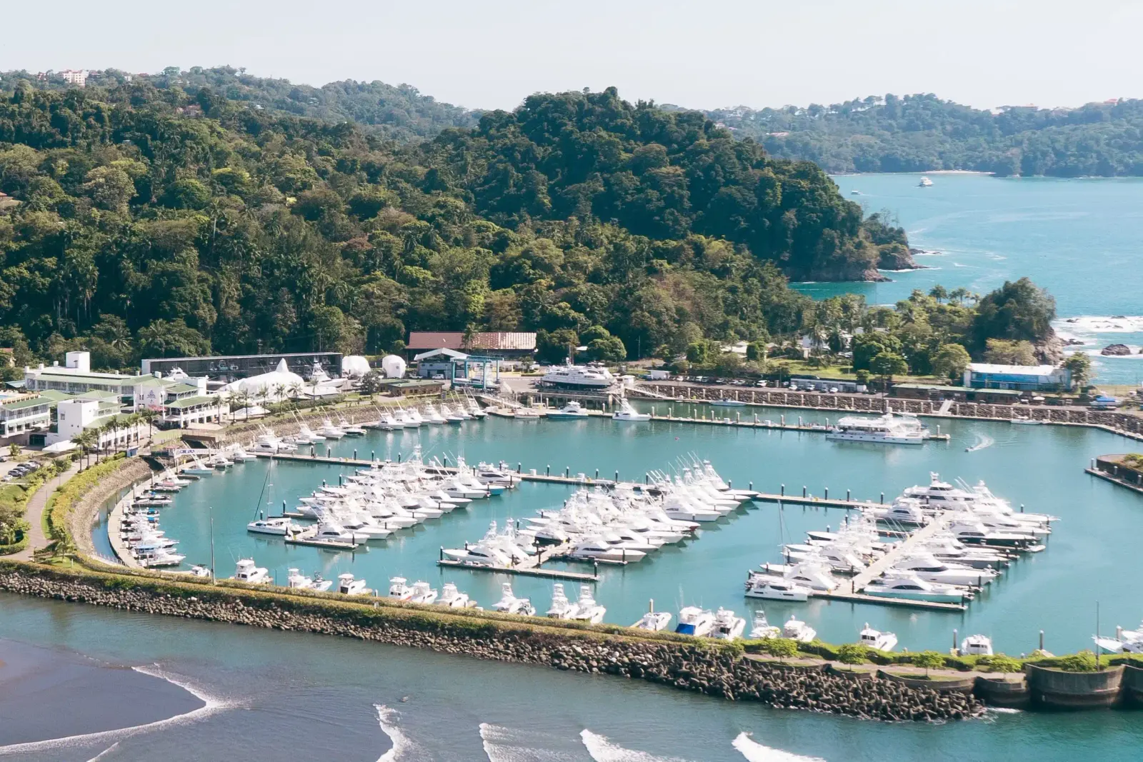 Aerial view of Marina Pez Vela in Quepos, home port of Vuelto Loco, with forested hills behind