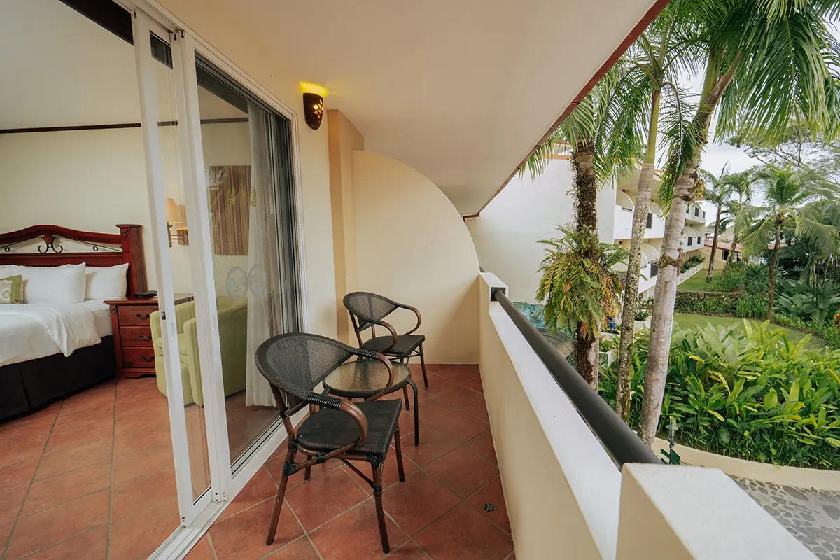 Tropical Room balcony with wicker chairs among the trees