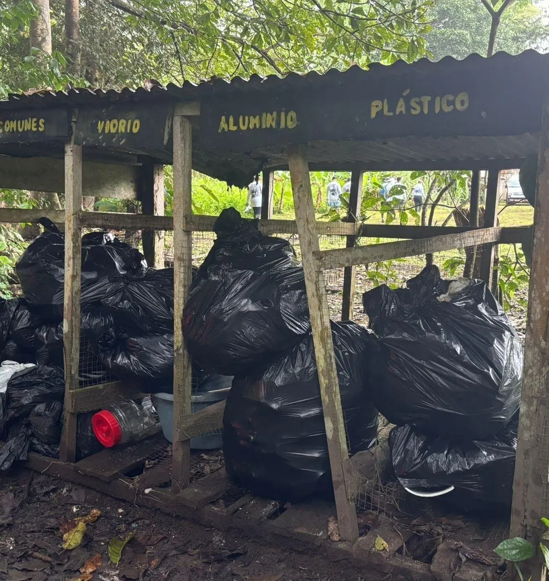 A recycling station with bins labeled for glass, aluminum and plastic