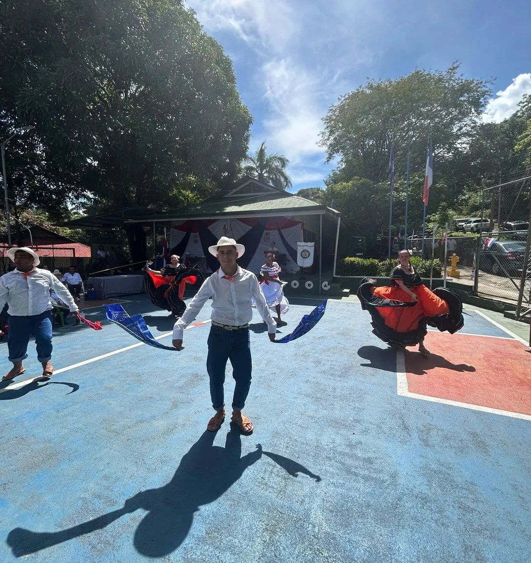 Dancers in traditional Costa Rican dress performing outdoors