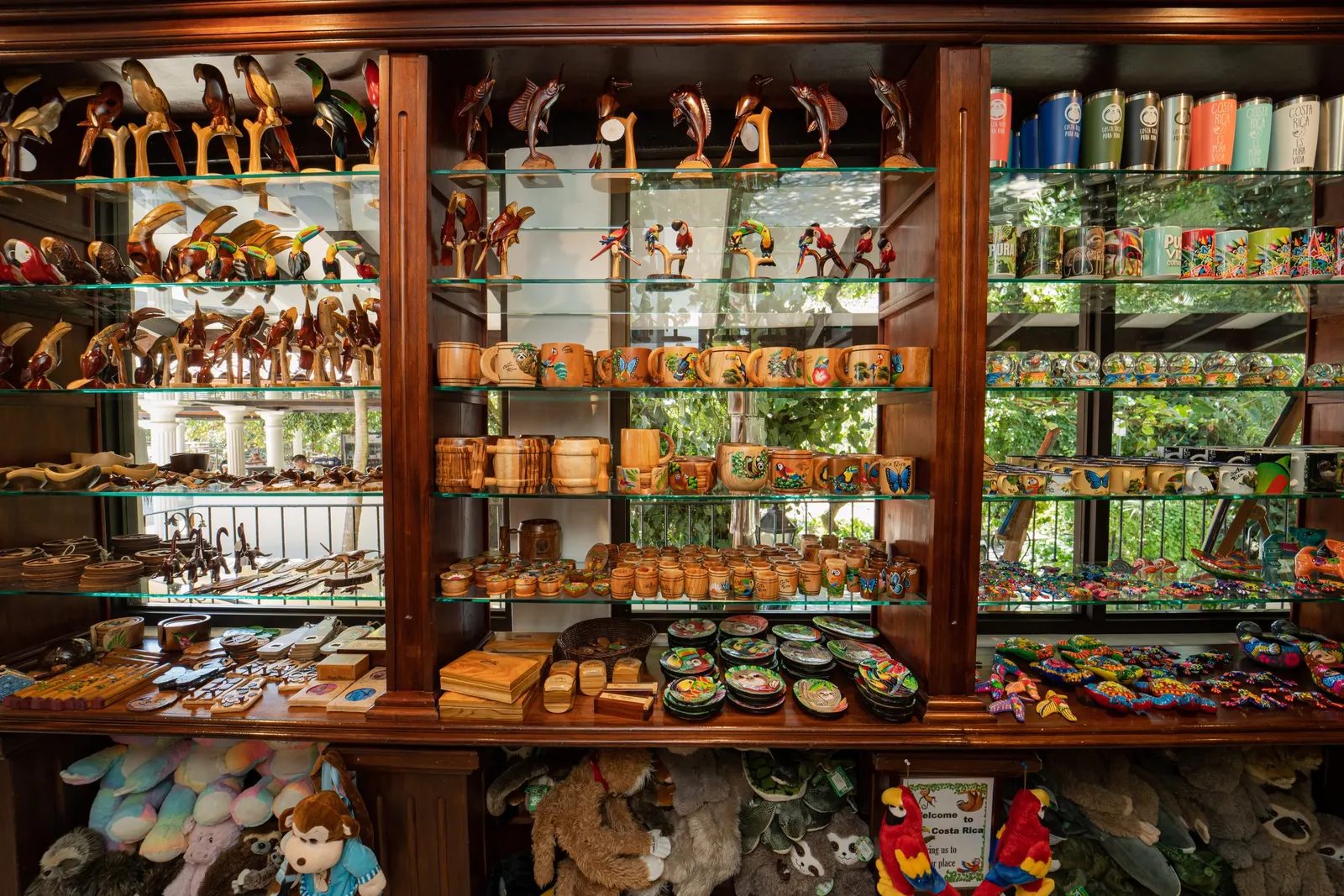 Shelves of hand-carved wooden animals, painted crafts and souvenirs in the Parador gift shop