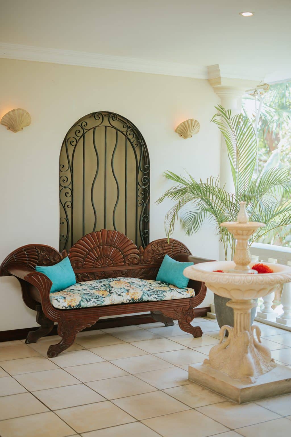 Relaxation lounge with a carved bench and a stone fountain