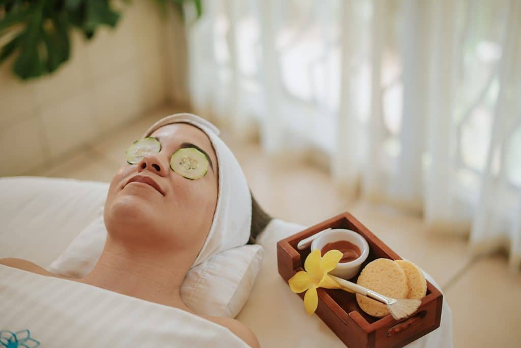 Guest resting during a facial with cucumber over the eyes