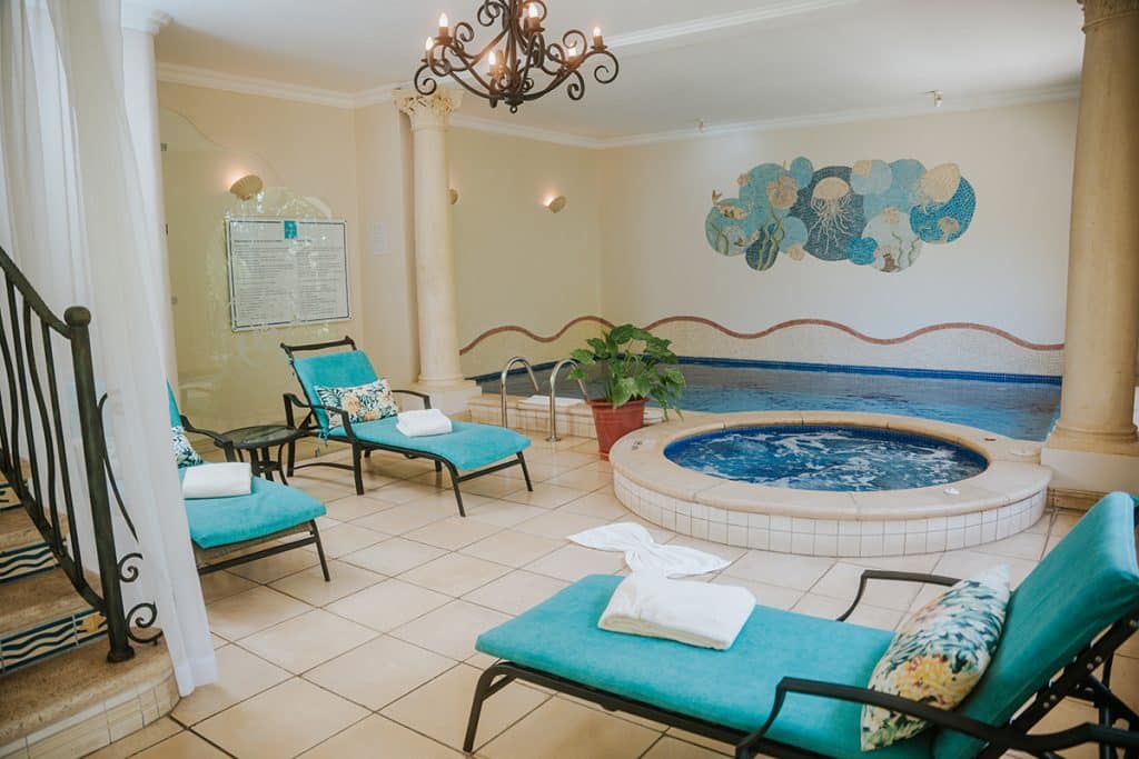 Indoor hot tub with turquoise loungers