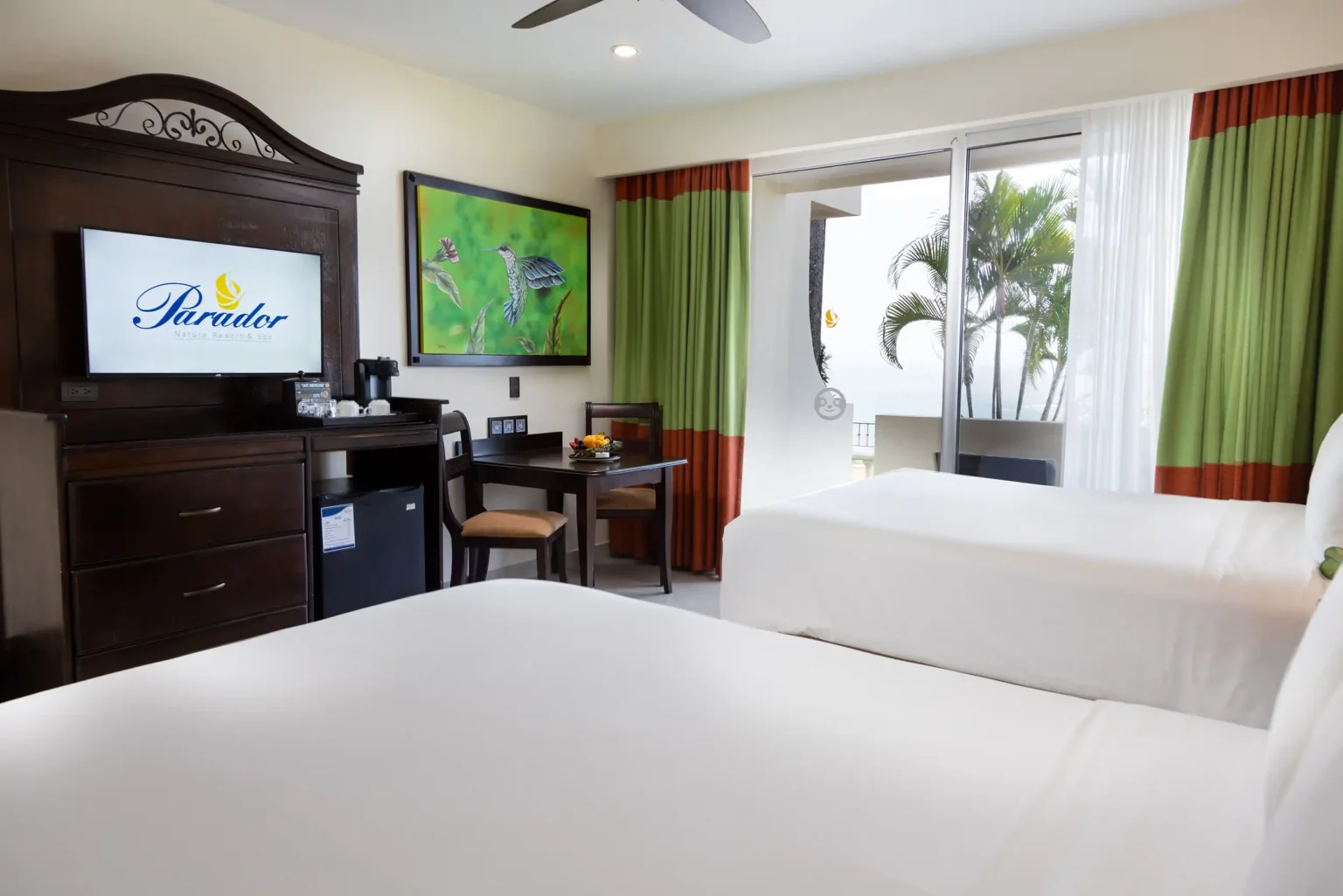Premium Room with white bedding and a balcony facing the palms