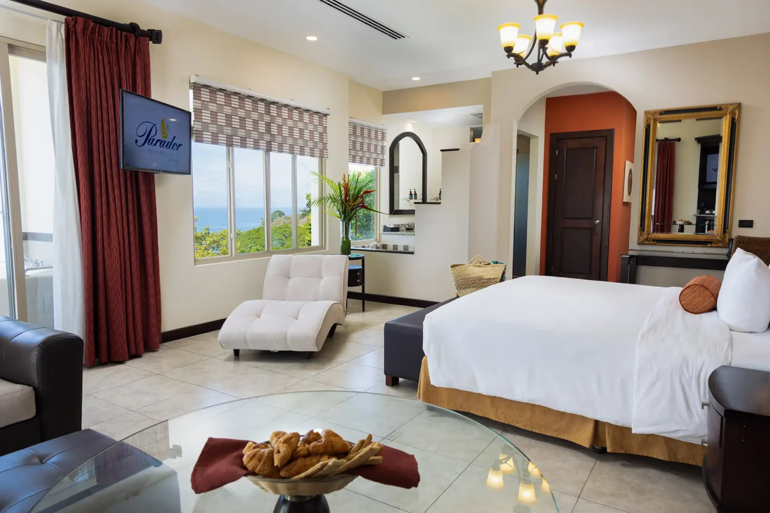 Vista Pacifico room with king bed, chaise lounge and an ocean view window