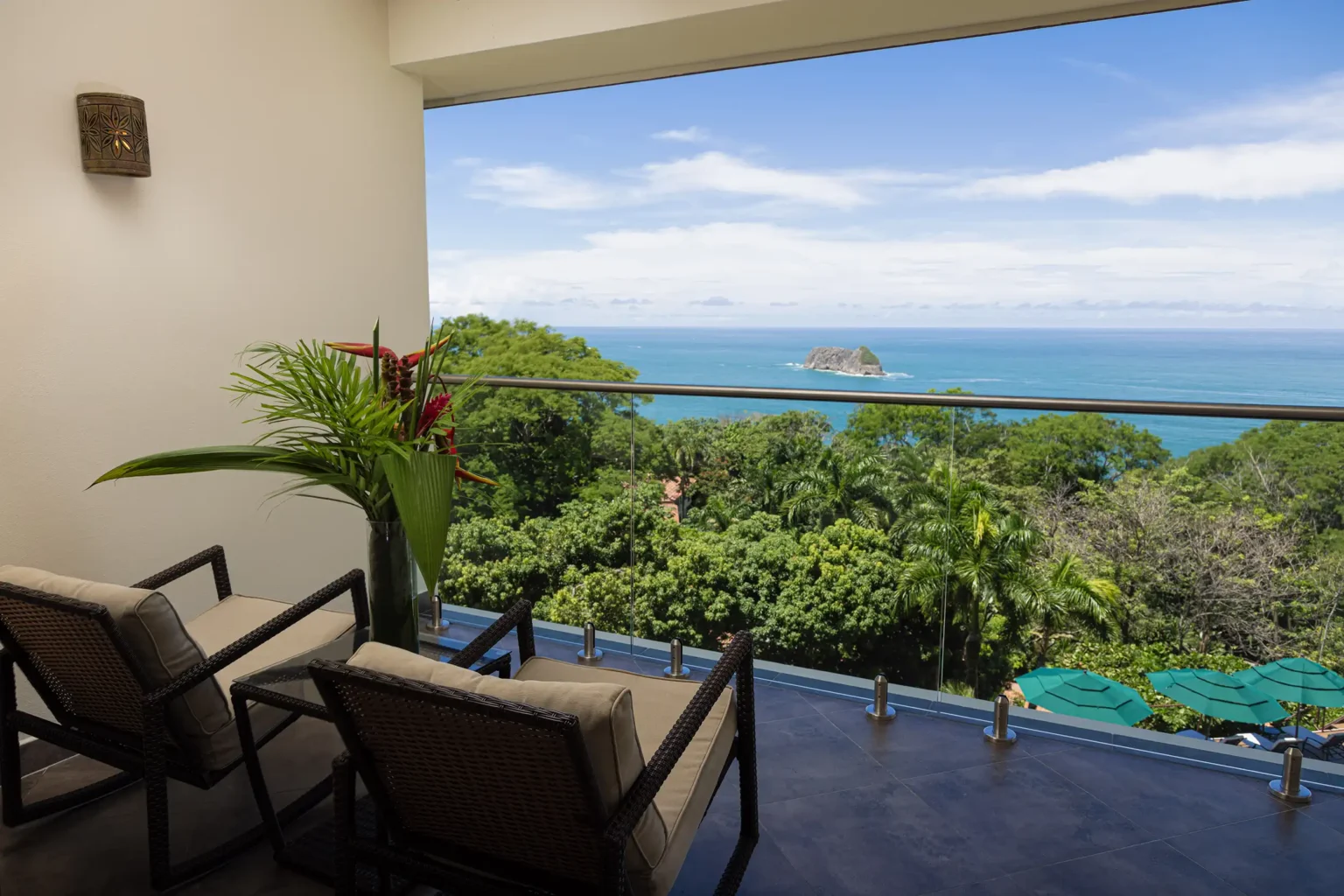 Vista Suite balcony with two chairs looking over the rainforest to the Pacific